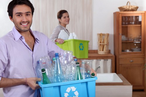 Professional clearance workers organizing items in a living room